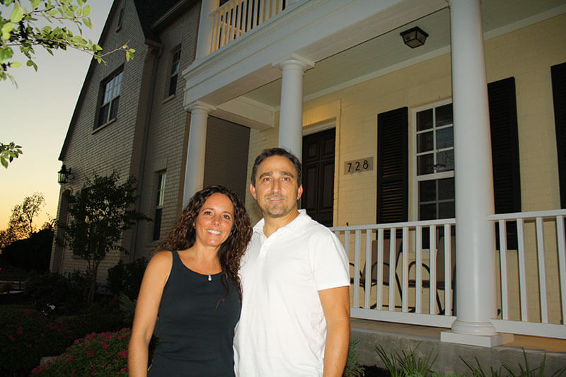 Couple in front of home