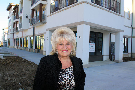 Roxann Taylor stands in front of his corner property shop at Lakeside where she will introduce a whole new concept in marketing real estate. 