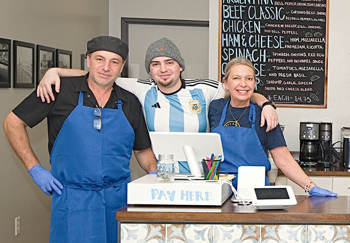 Cacho family behind counter